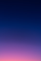 a group of people standing on top of a beach