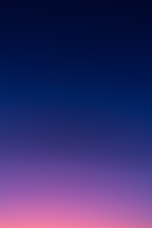 a group of people standing on top of a beach