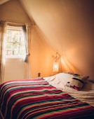 Cozy loft bedroom featuring built-in storage and soft lighting.