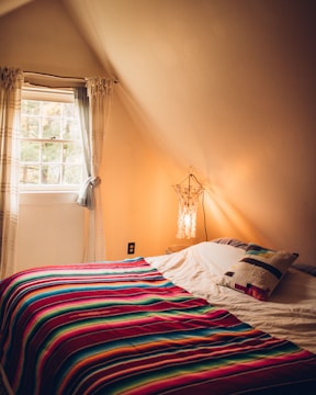 A cozy bedroom featuring a layered pop ceiling with warm LED strips creating ambient light