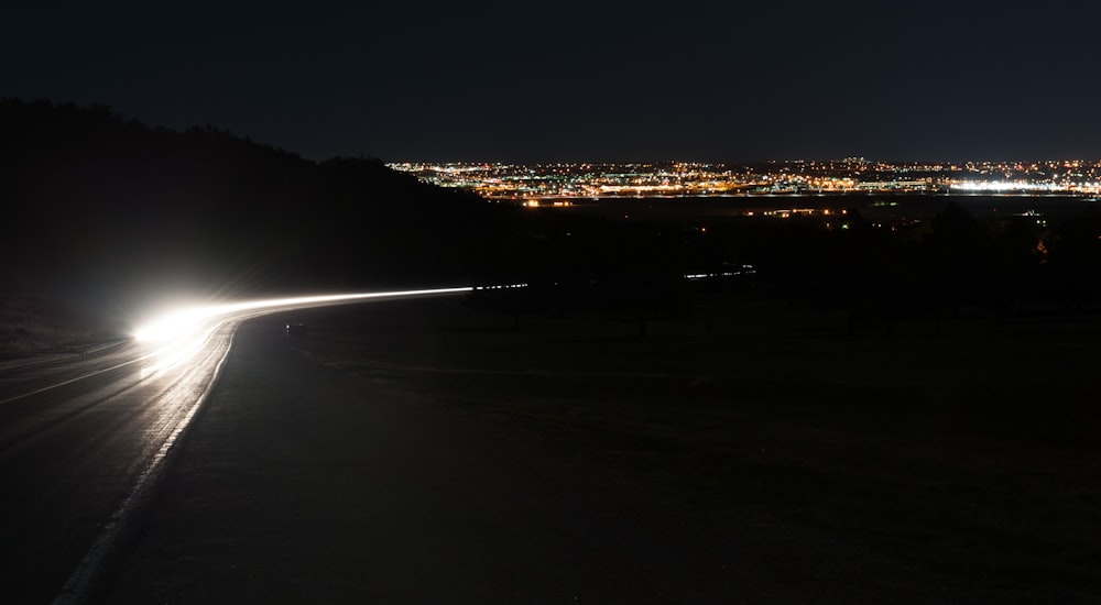 a car driving down a road at night