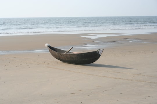 brown wooden boat on seashore during daytime in Kumta India