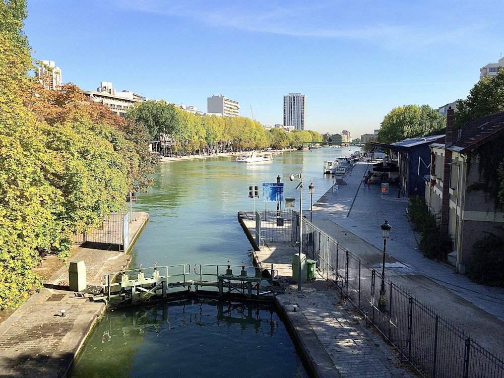 river beside concrete building during daytime