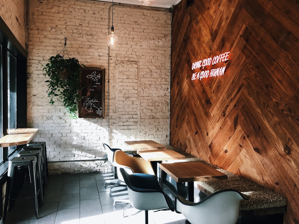 chairs and tables beside wall