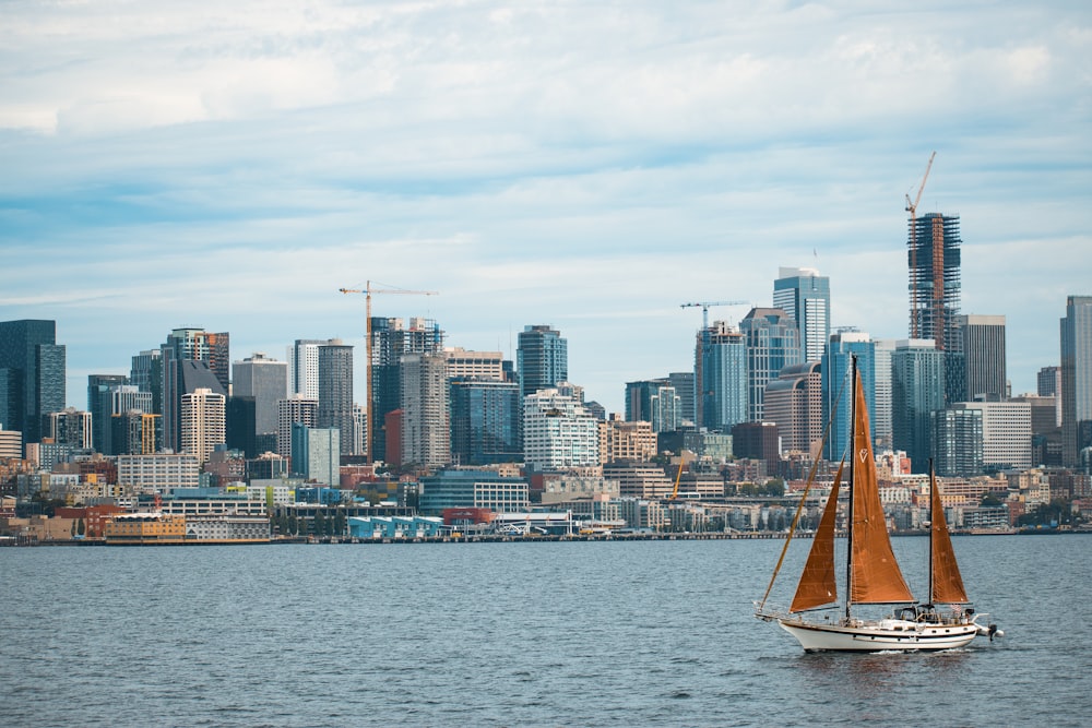 white and brown sailboat on the beach