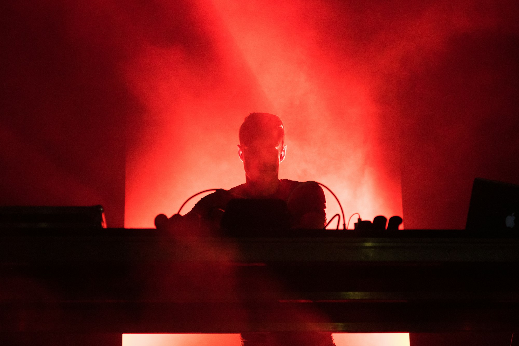 DJ playing music in red lights