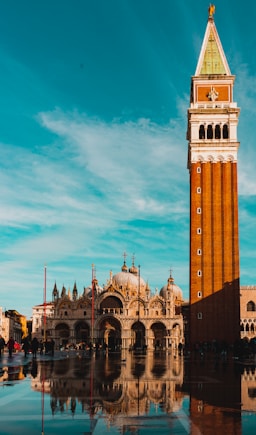 torre marrom e branca ao lado de imponente basílica