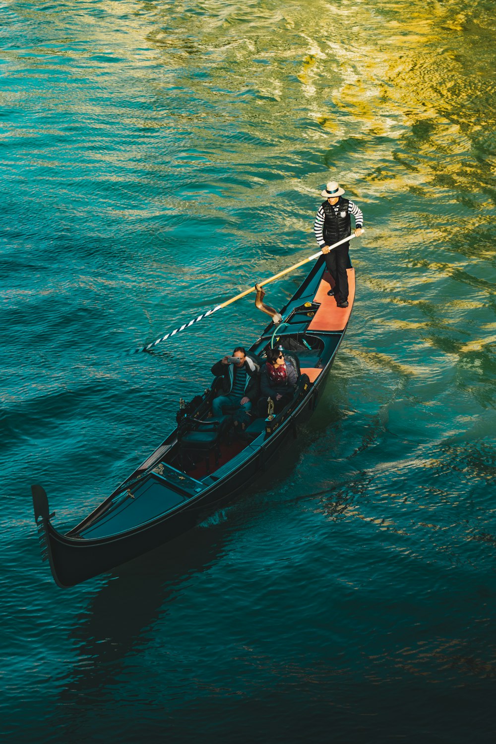 people on boat on body of water