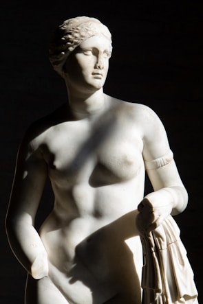 Elegant marble statue capturing soft curves and textures under natural light.