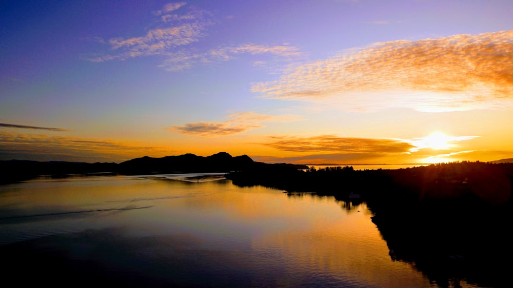 calm body of lake under golden hour