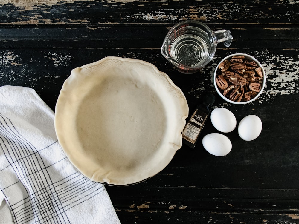 empty white plate beside three eggs