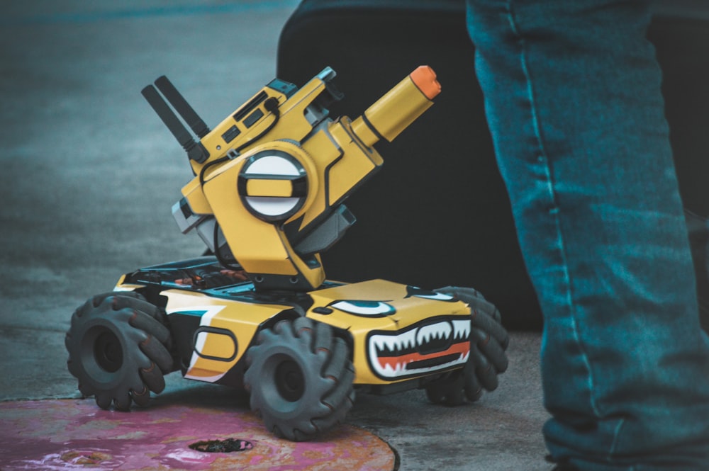 yellow and black 4-wheeled robot vehicle toy