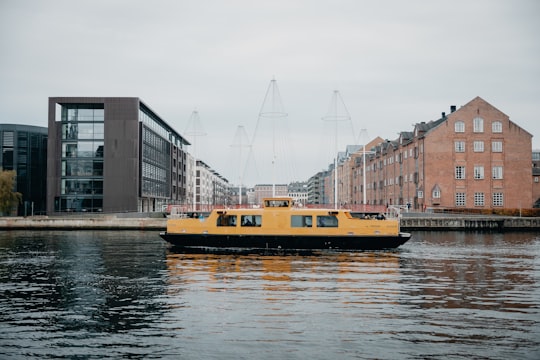 yellow and black passenger boat on river in The Black Diamond Denmark