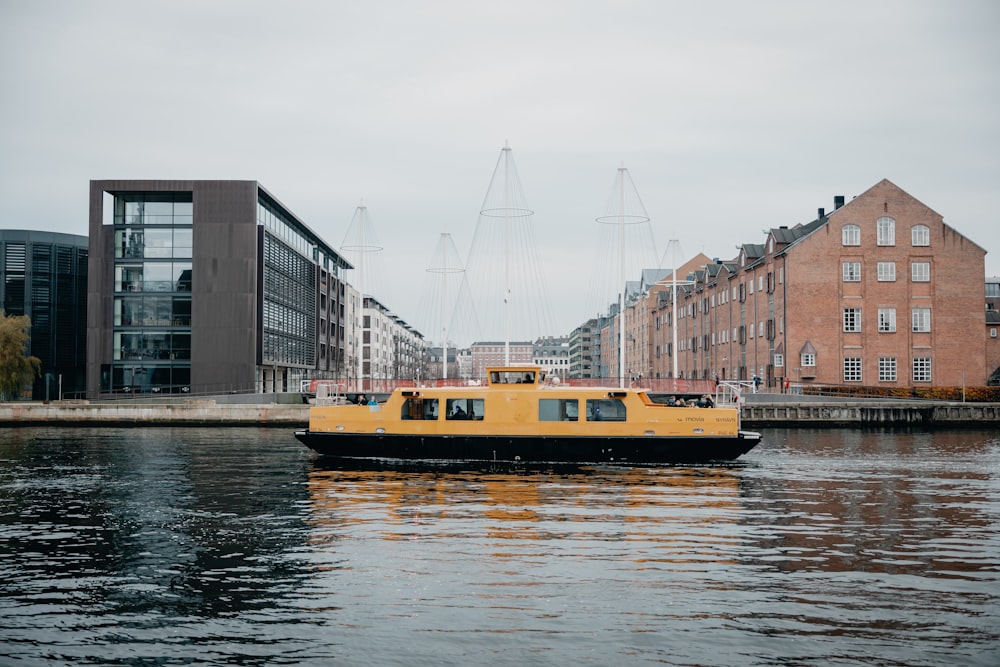 yellow and black passenger boat on river