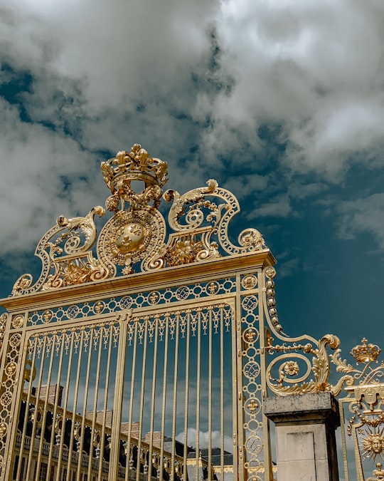 closed gold metal gate in Palace of Versailles France