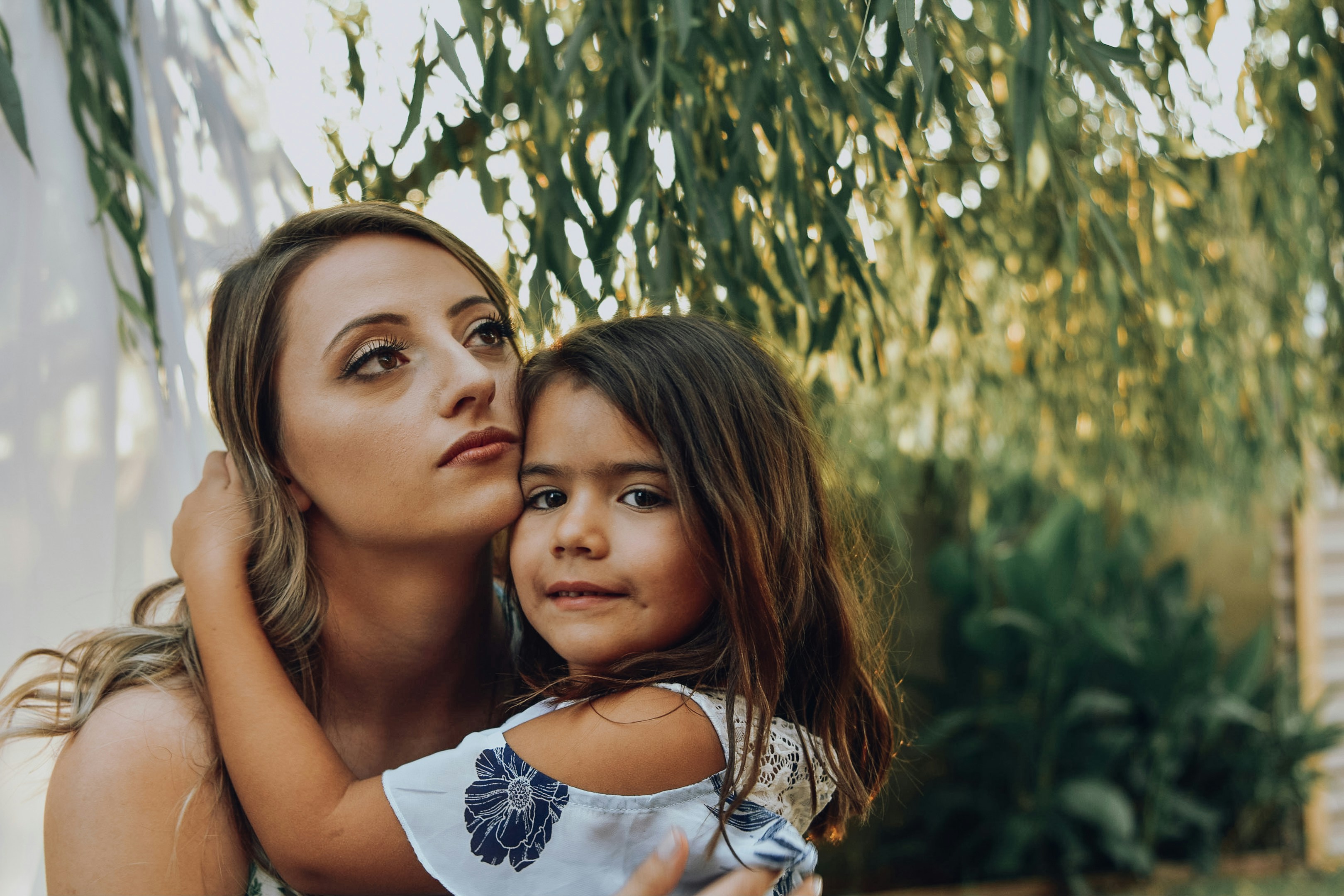 selective focus photo of woman carrying a girl