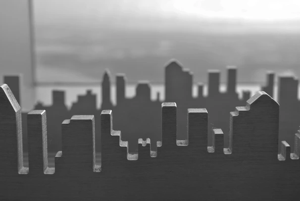 A minimalist black and white ink drawing of a city skyline.