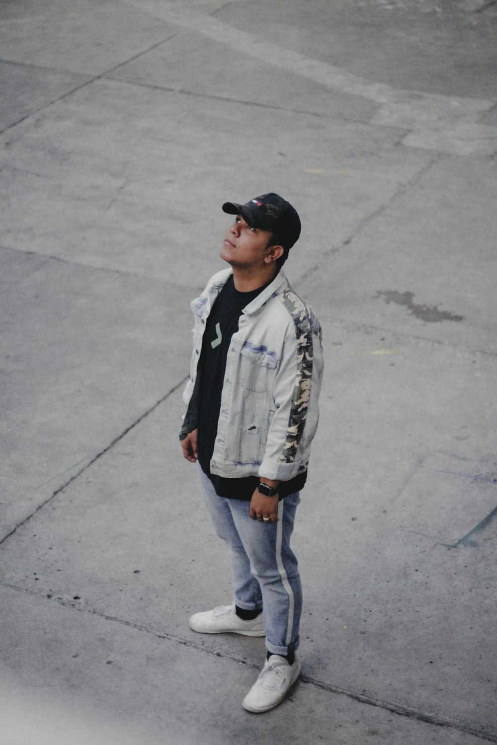 man standing on grey pavement