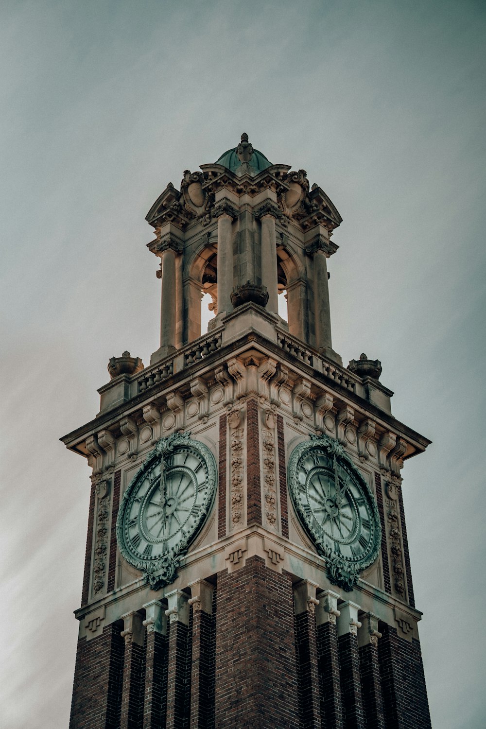 brown concrete tower clock during daytime