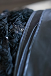 Close-up of elegant fabric textures and details on formal dresses and suits.