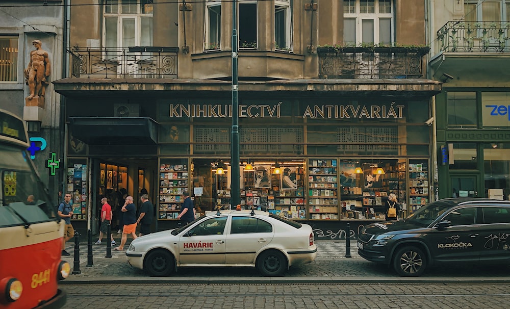 people and cars near buildings during day