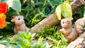 A charming resin animal figure nestled among natural greenery