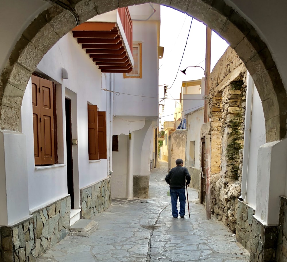 man walking near white concrete building