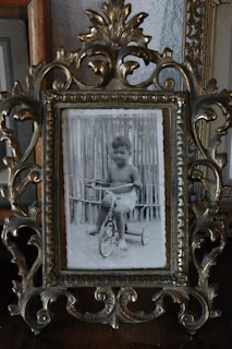 A black and white tintype of a child playing with a wooden toy, full of nostalgic charm.