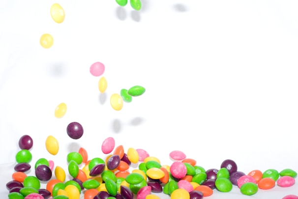 A colorful display of confetti, candies, and lollipops.