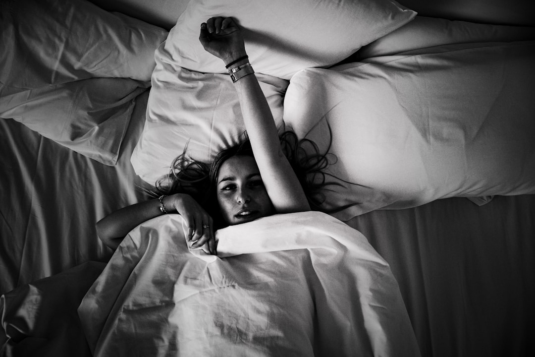 Person lying awake at night unable to fall asleep