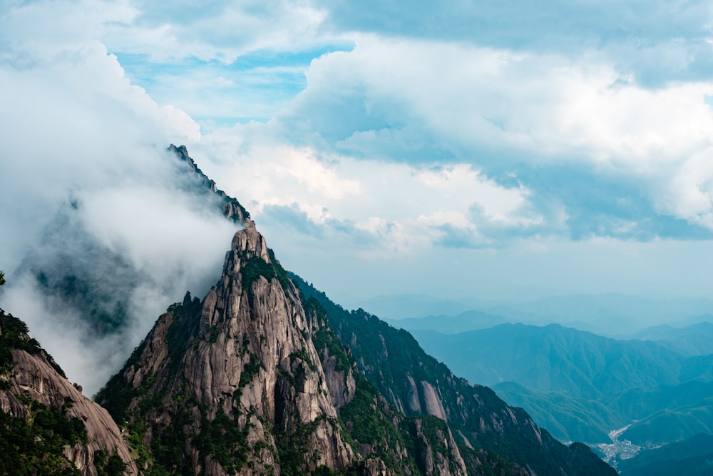 rocky mountain under cloudy sky during daytime