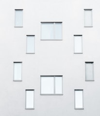 Close-up of a minimalist house facade with large windows and neutral colors.