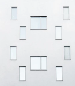 Minimalist architectural detail of a modern building facade in warm neutral tones.