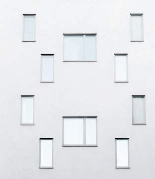 Minimalist architectural facade with warm neutral tones and subtle gold accents.