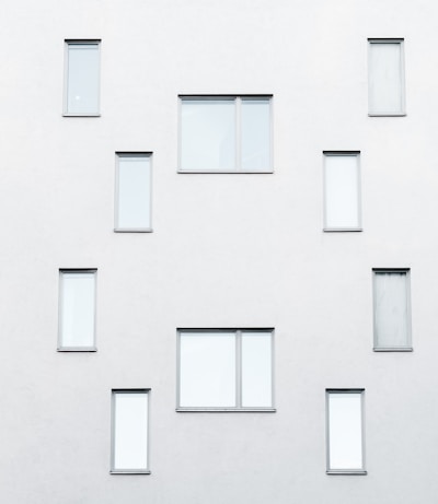 Close-up of a minimalist house facade with large windows and neutral colors.