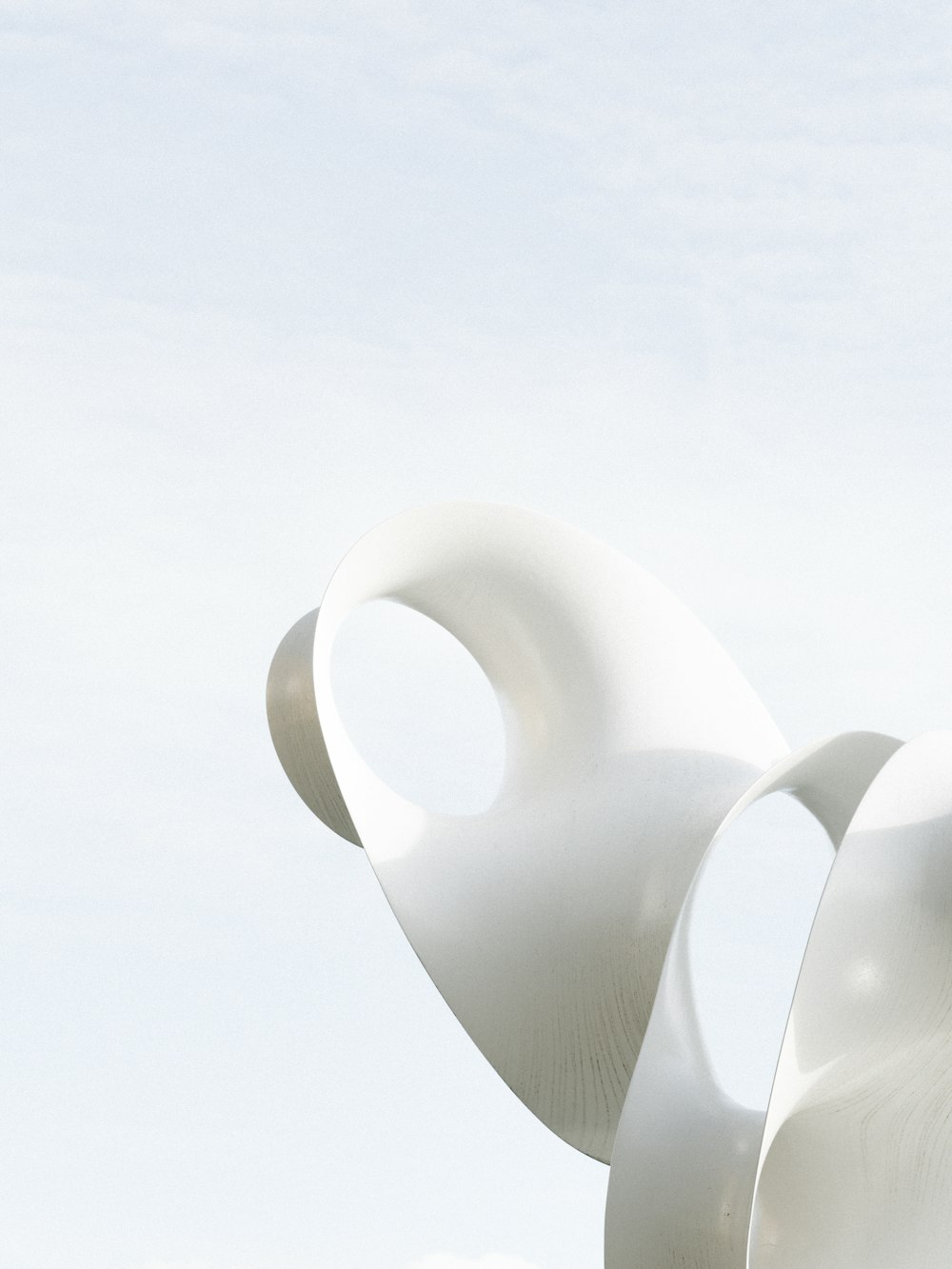 a large white sculpture sitting in the middle of a field