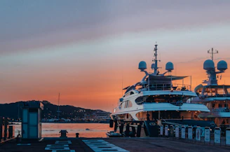 white boat docked on docking area