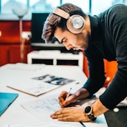 man wearing headset drawing