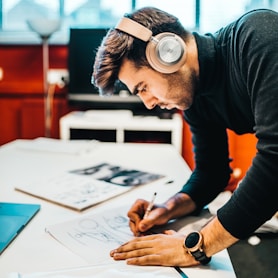 man wearing headset drawing fashion projects