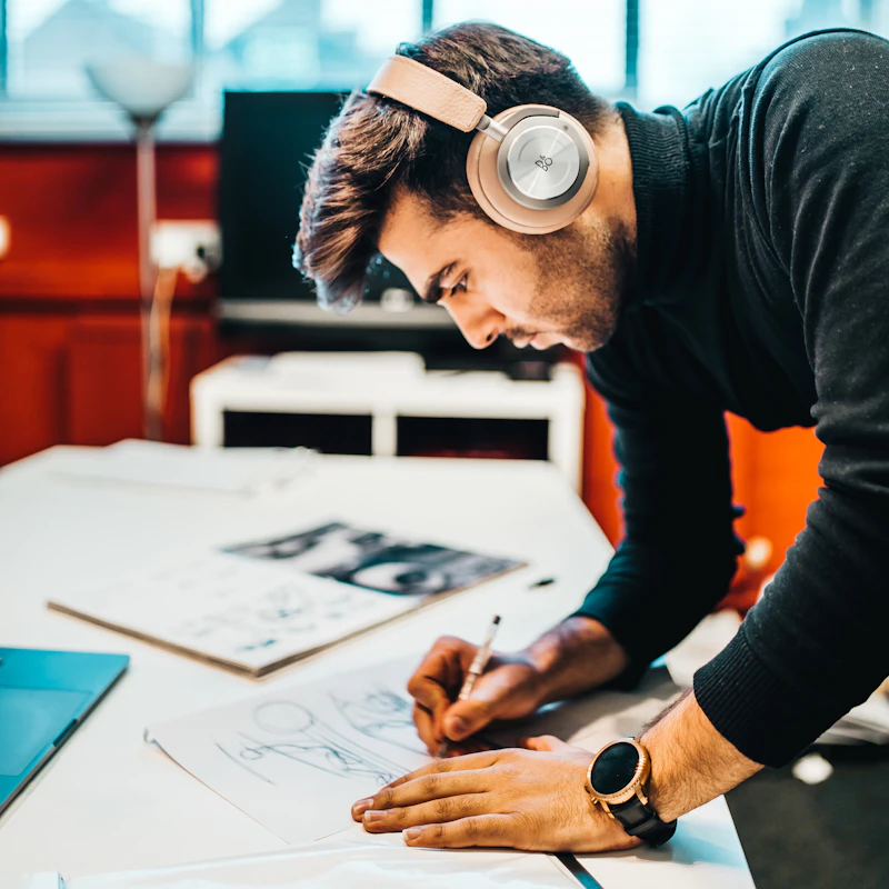 Designer sketching product concepts on a digital tablet, representing brand and product development