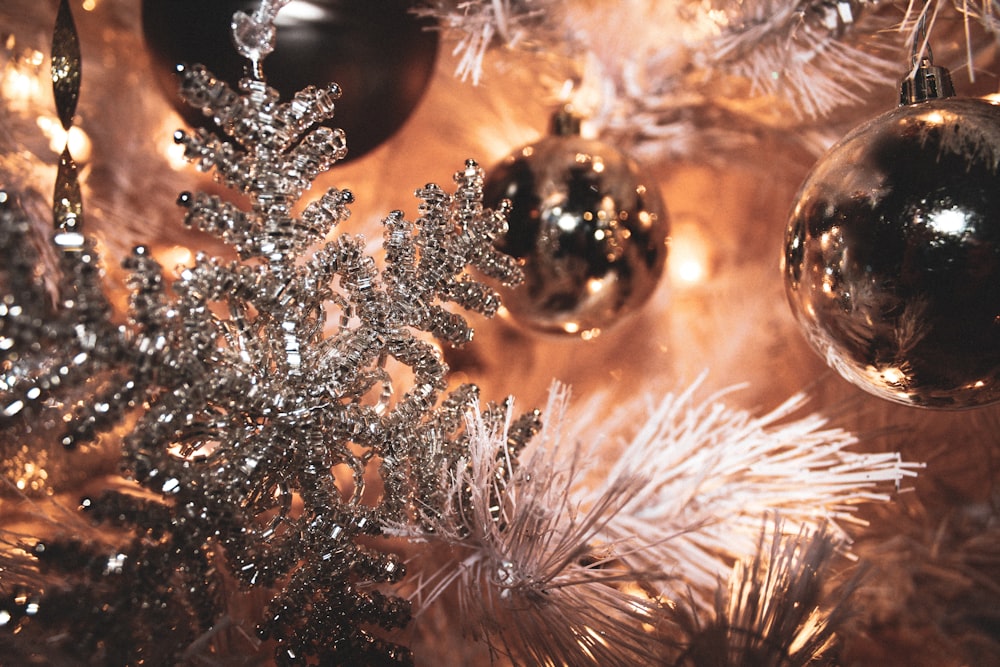 selective focus photography of gray Christmas bauble and snowflakes