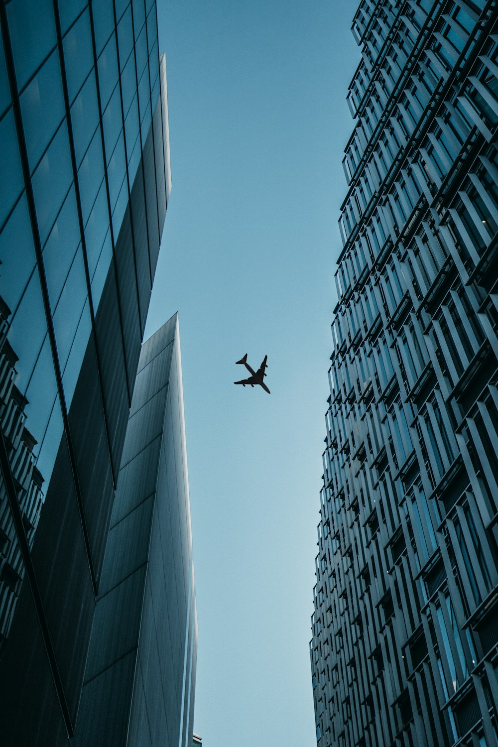 flying airplane above high-rise airplanes