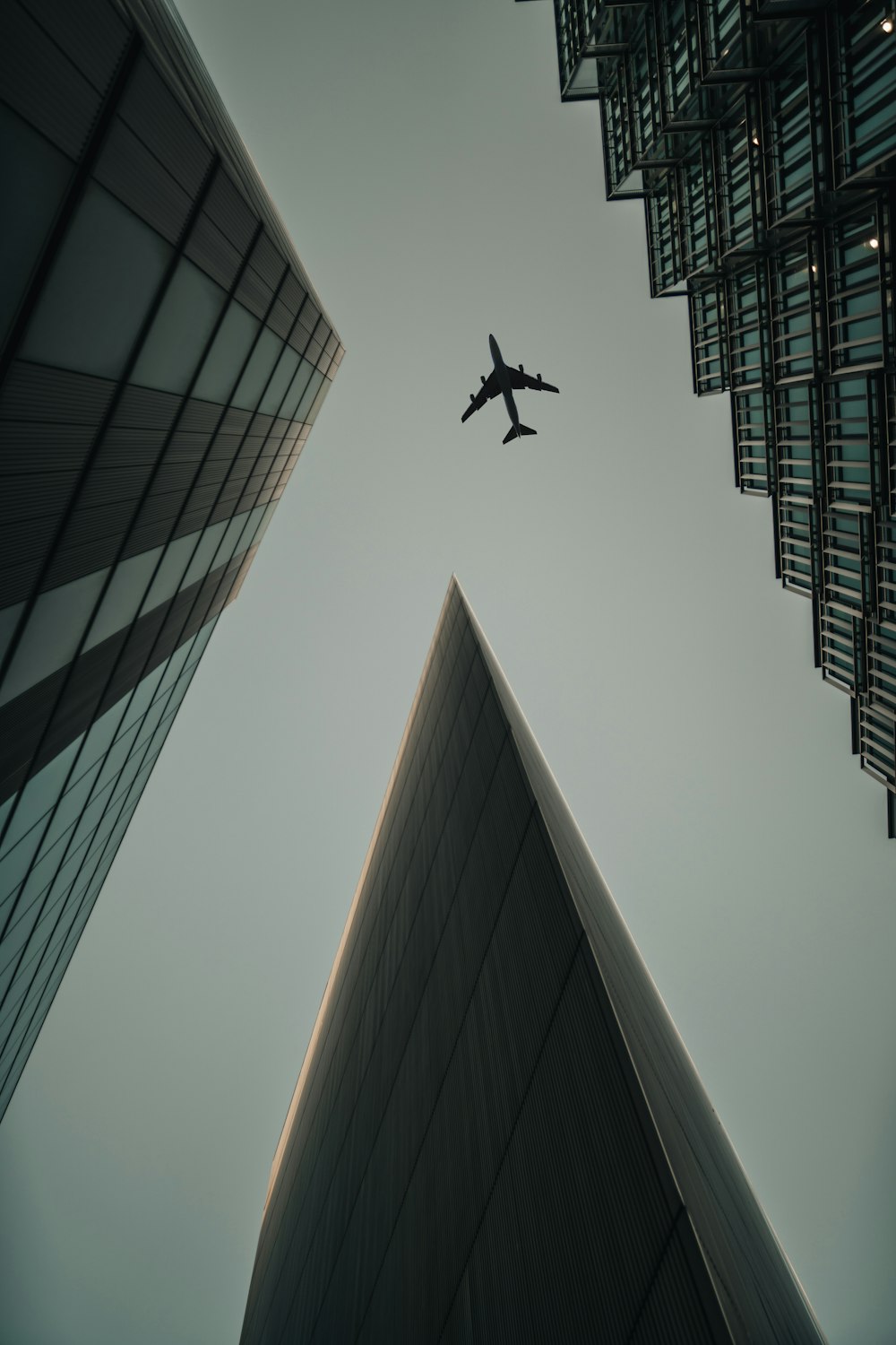 flying airplane above high-rise buildings