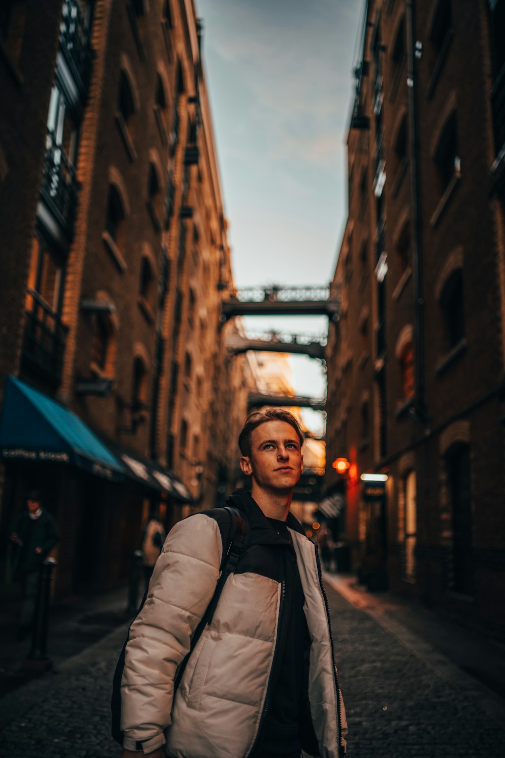 selective focus photography of man standing on alley