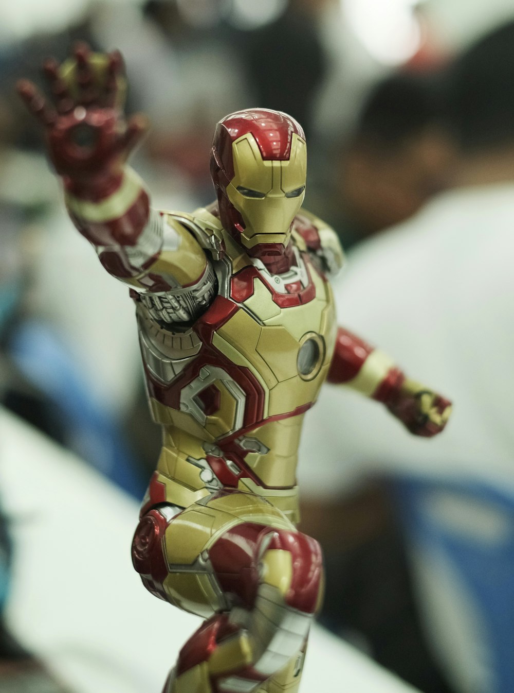 selective focus photography of gold and red Iron Man action figure