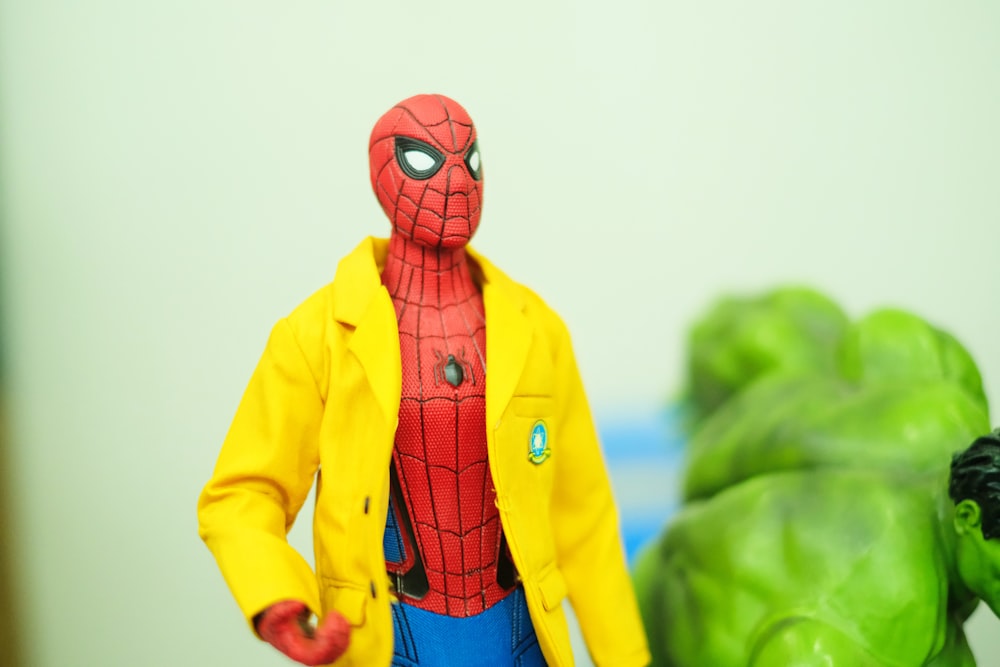 selective focus photography of Spider-Man wearing yellow jacket action figure