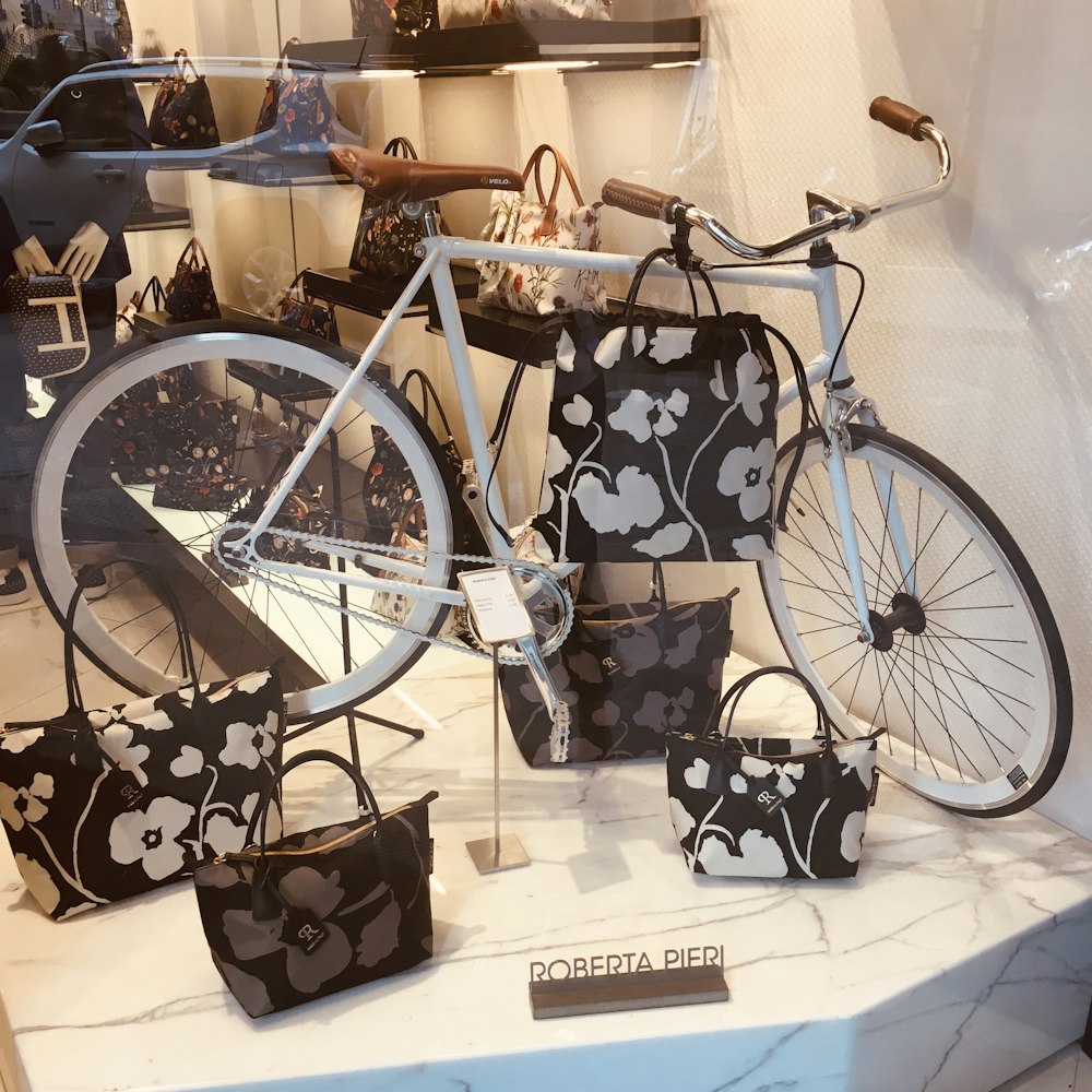 white bicycle and floral leather tote bags