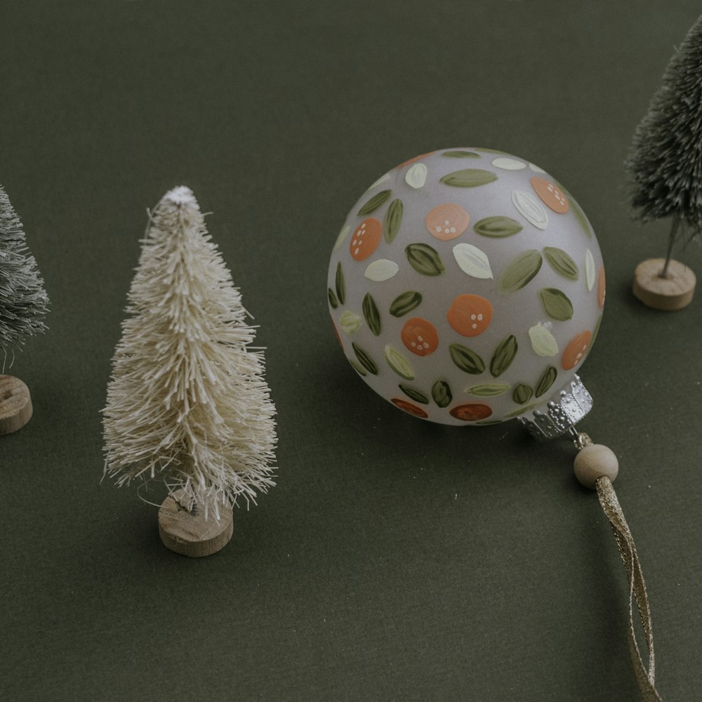 Christmas tree miniature beside bauble ball