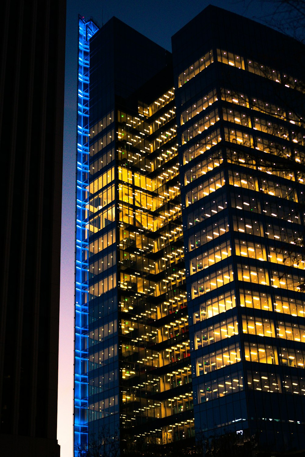 gray building with yellow window light