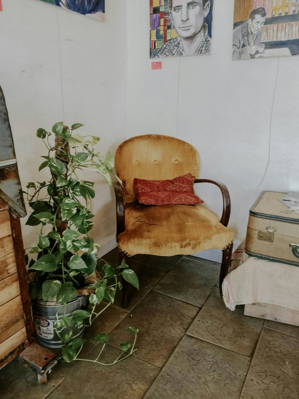 brown armchair beside wall